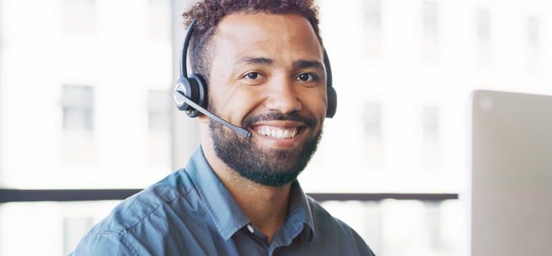 Man wearing a headset and smiling