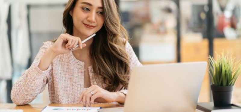 A woman looking at her laptop