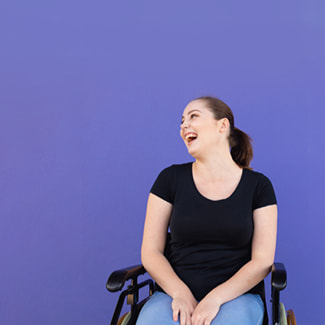 A woman in a wheelchair smiling