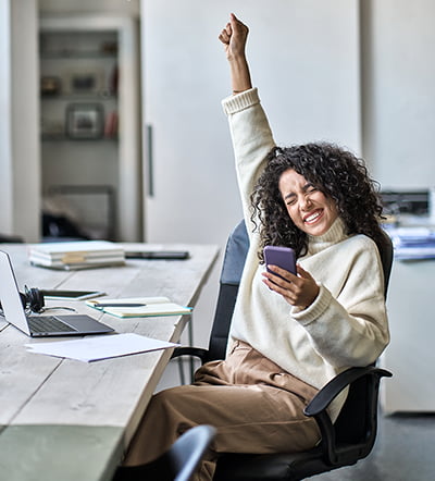 Excited employee sitting at their desk