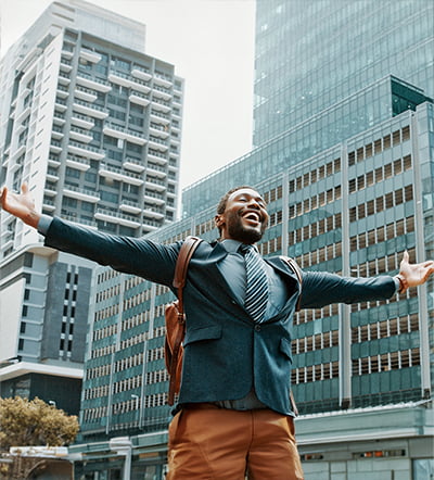 Person walking down a city street looking happy