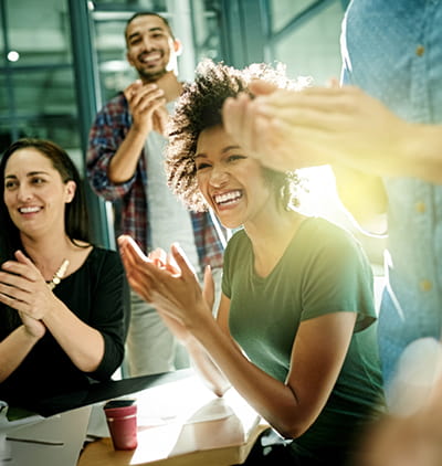 Group of people clapping in a conference room