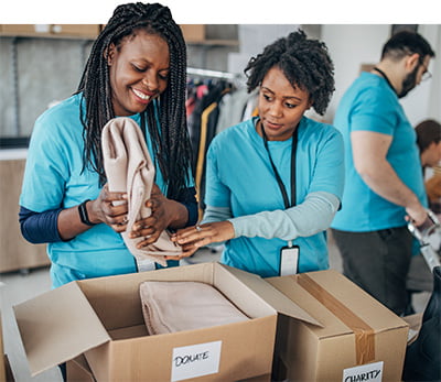 Group of people packing boxes with charity items