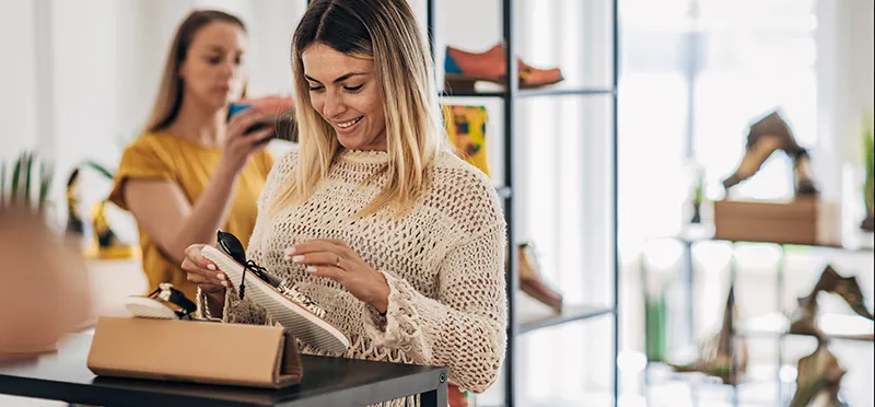 Woman looking at a shoe in a shoe store