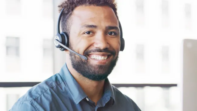 Man wearing a headset and smiling
