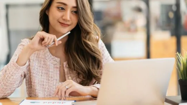 A woman looking at her laptop