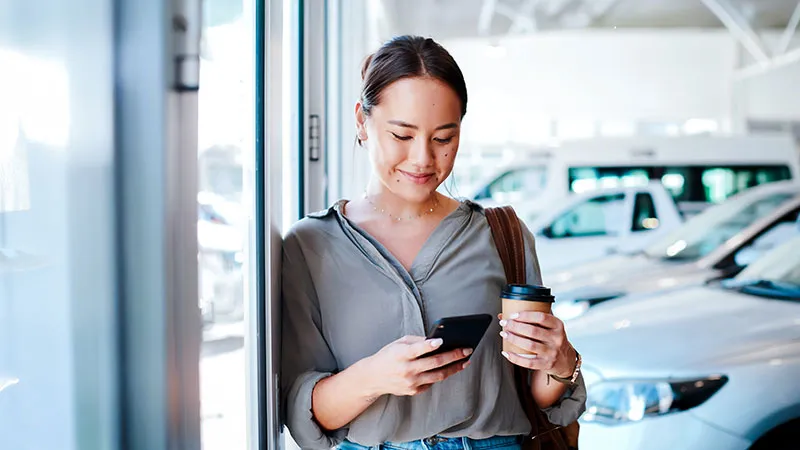 A woman on the phone at a dealership