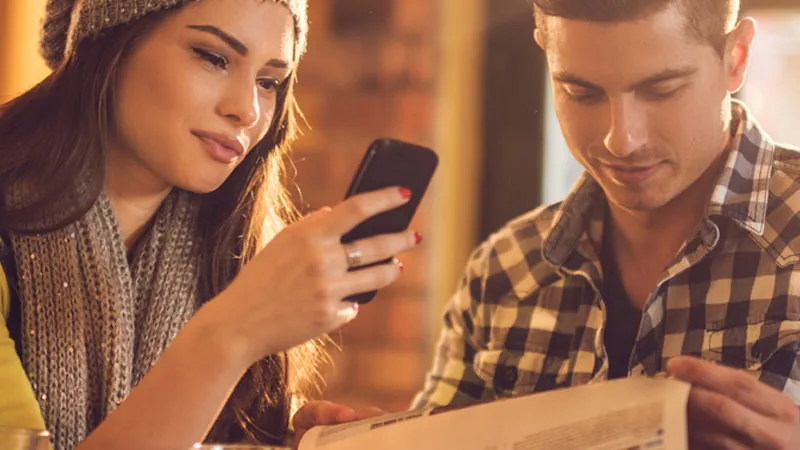 Group of people in a shop reading