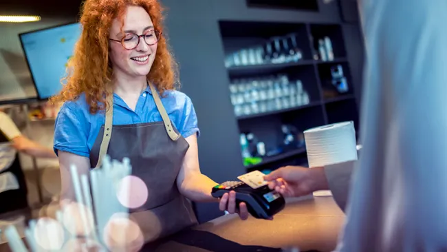 A cashier accepting card payment