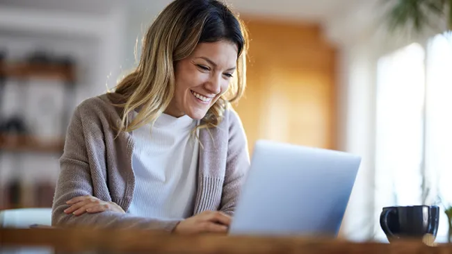 A woman virtually talking to someone via laptop