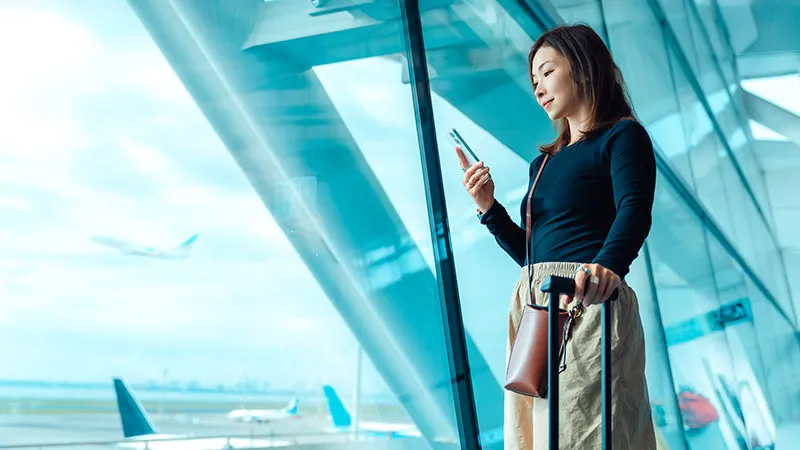 A woman on the phone at the airport