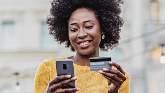 Woman on phone entering her payment information