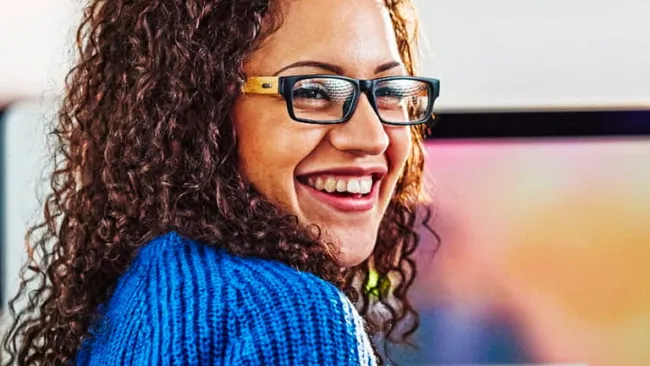 Woman smiling while sitting in office chair