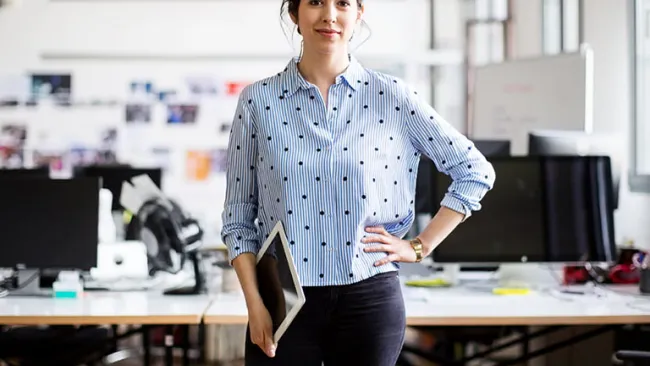 Woman at work holding tablet