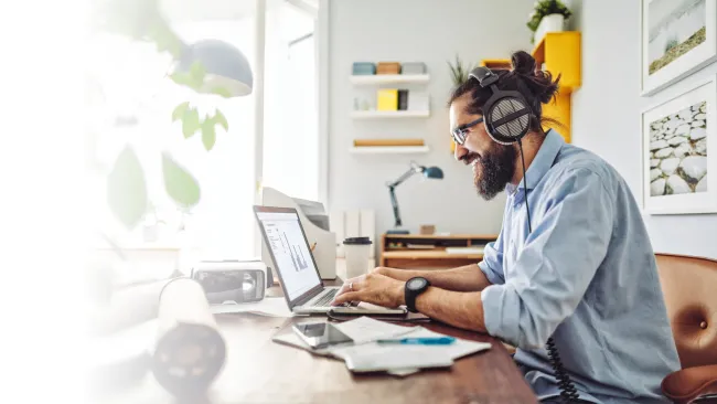 Man working on his laptop in his home office