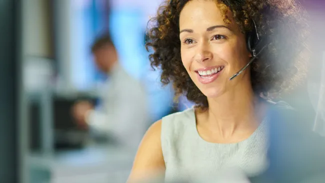 Contact center worker smiling while working