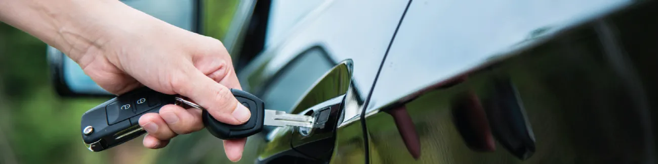 Person putting a key into their car door