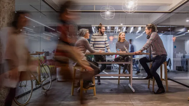 Group talking at table in office setting