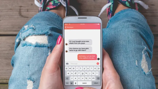 Person chatting on their phone with a sales associate