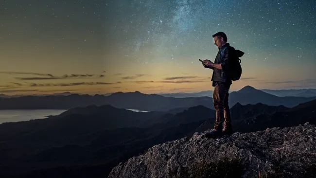 Man standing on mountain at dusk