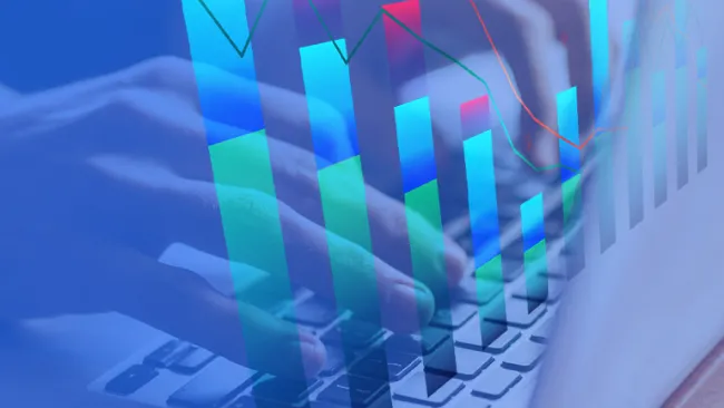 Bar charts overlayed over an image of a person using a laptop keyboard