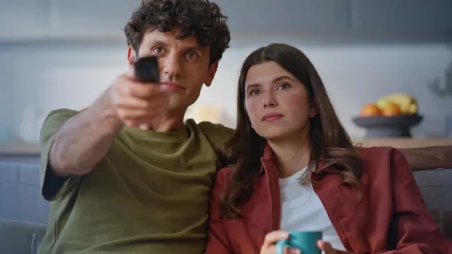 A couple streaming a show in their living room