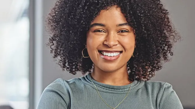 Woman smiling while looking into camera