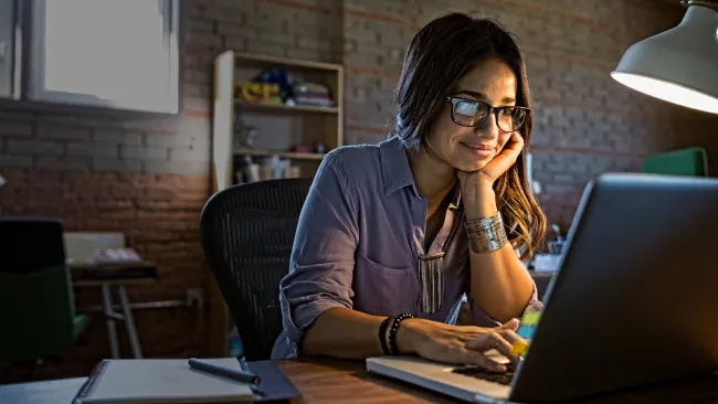 Woman sitting in office her her laptop