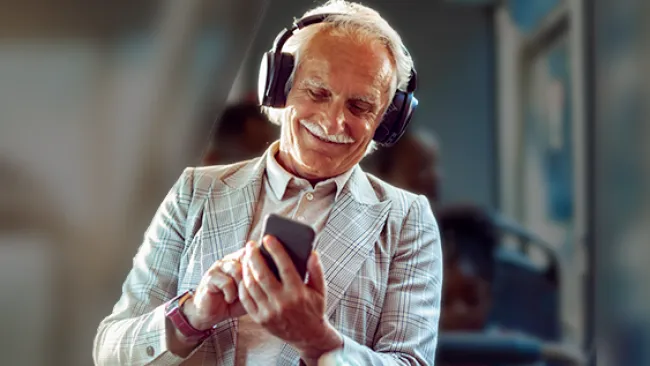 Man using phone on a bus
