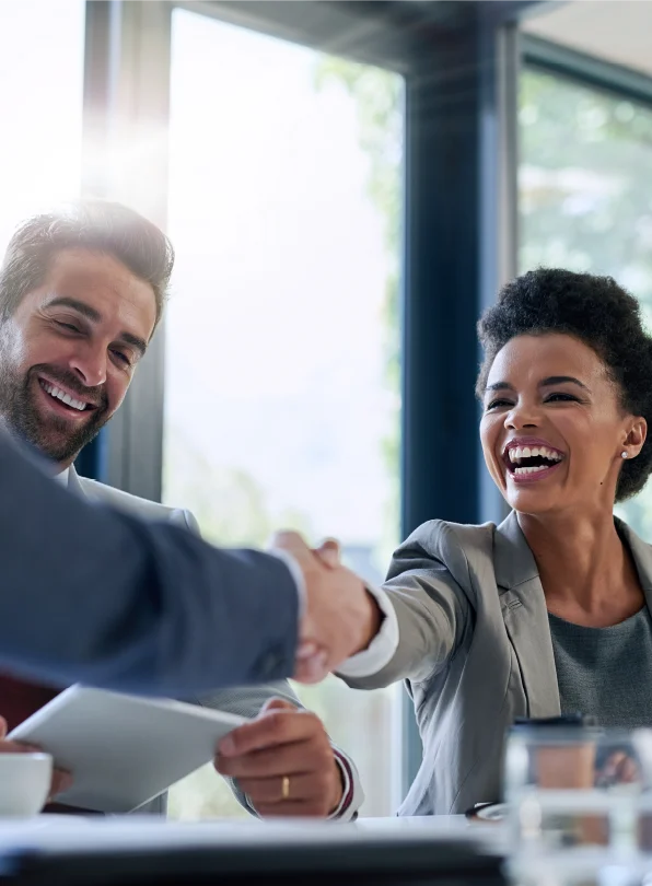 Shaking hands in a conference room