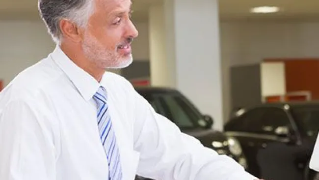Three people having a conversation near a desk