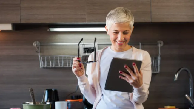 A woman looking at her tablet