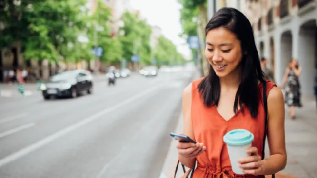 A woman on the street texting