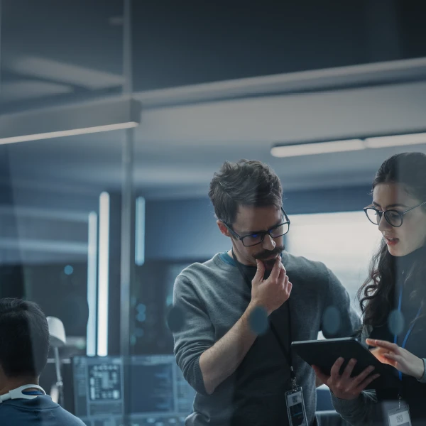 Cowokers collaborating around a tablet