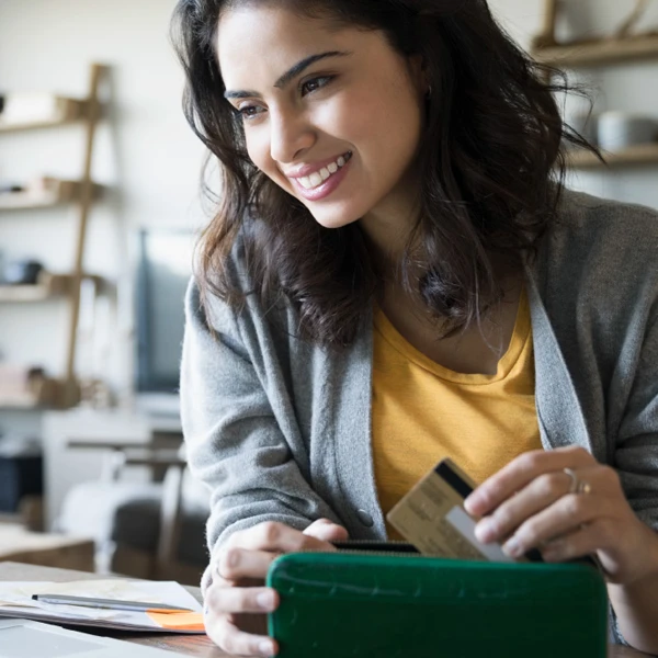 Woman taking her credit card out of her wallet