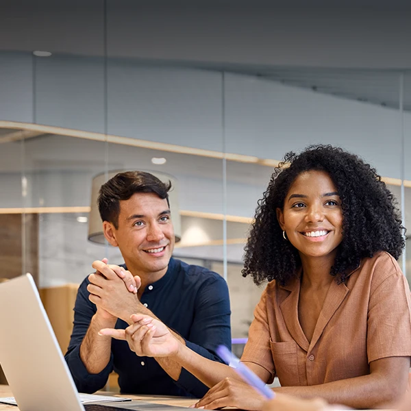Two employees sitting in a conference room