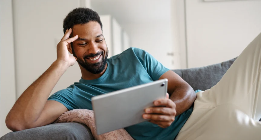 Customer using a tablet on their couch