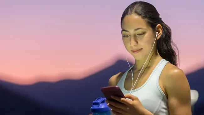 Woman in mountains looking at her phone